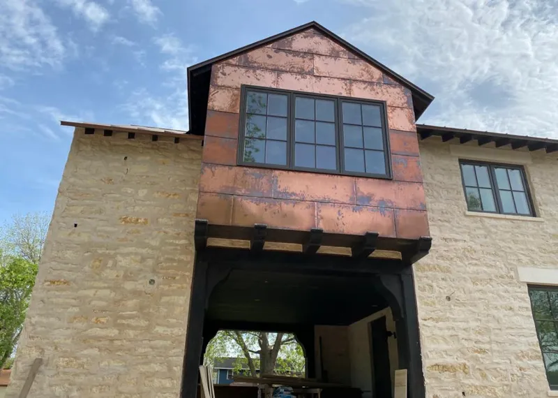 Copper metal panel facade on a stone building for Metal Roof Coating in Toledo