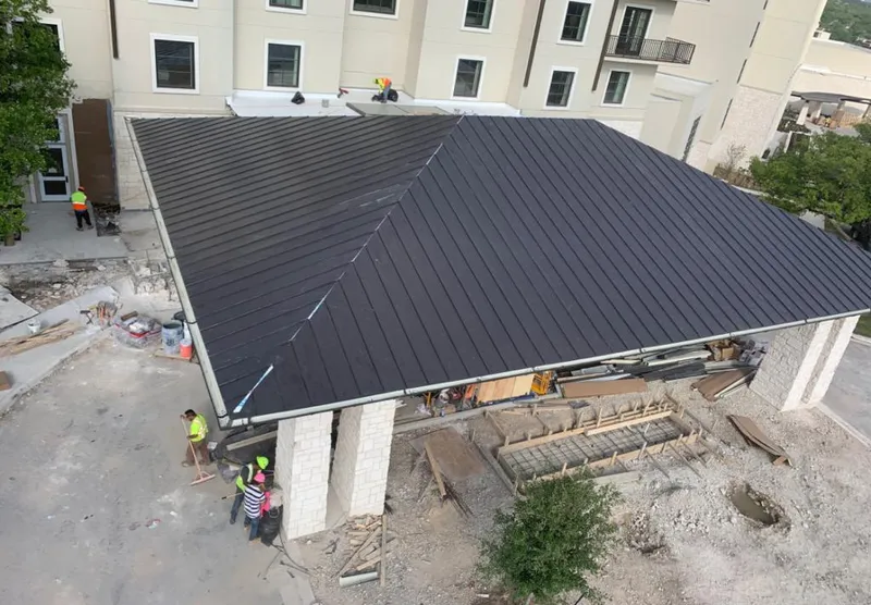 Metal roofing installation team working on a commercial building in Toledo
