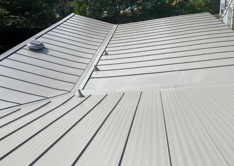 Solar attic fan installed on a metal roof for Roof Ventilation in Toledo